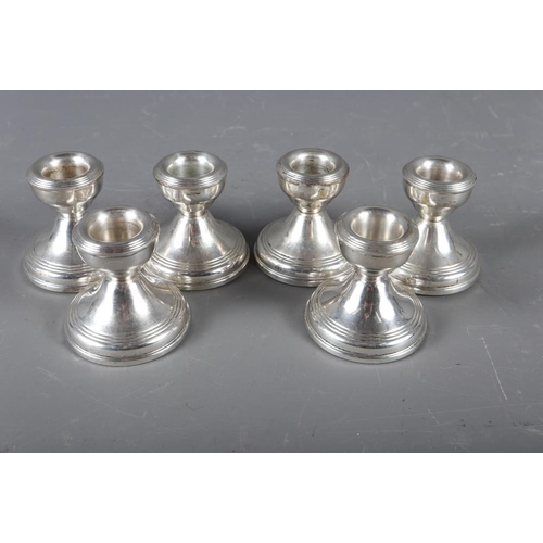 311 - A set of six filled silver squat candlesticks, 2 1/4