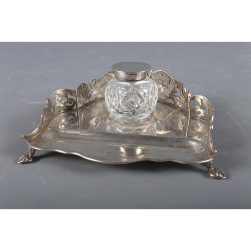 312 - A silver desk stand with pierced gallery and cut glass inkwell with silver lid