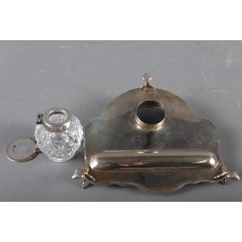 312 - A silver desk stand with pierced gallery and cut glass inkwell with silver lid