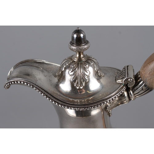 322 - An 18th century silver pedestal hot water jug with acorn finial, acanthus and laurel leaf decoration... 