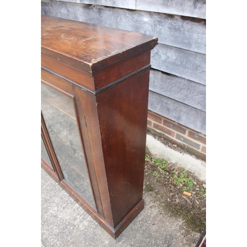 421 - A mahogany display bookcase enclosed glazed panel doors, on block base, 43