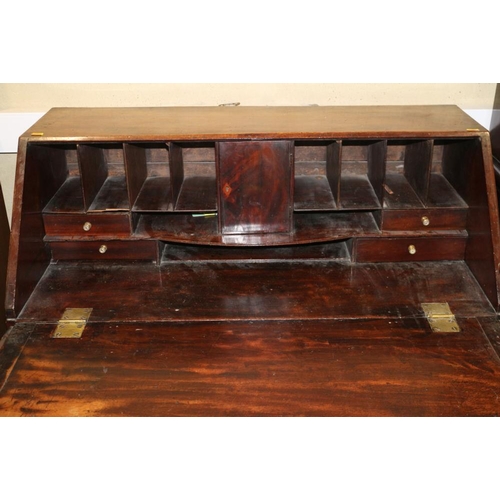 468 - A late Georgian mahogany fall front bureau, the fitted interior over four long graduated drawers wit... 