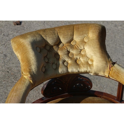 564 - A pair of Edwardian rosewood and inlaid tub-shape low seat armchairs, on turned and castored support... 