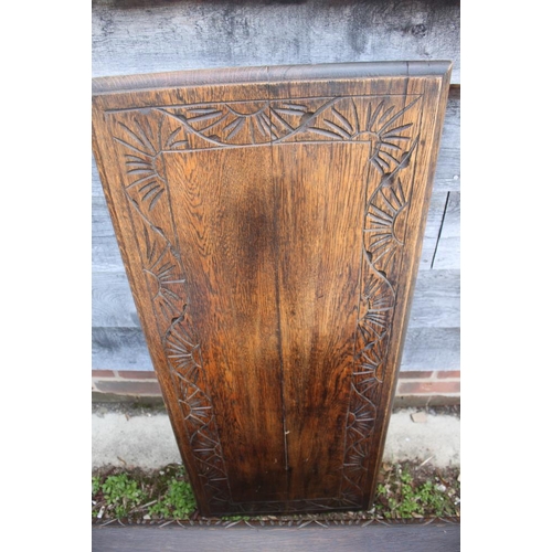 583 - A monk's carved oak bench with box seat and lion arms, 42 1/2