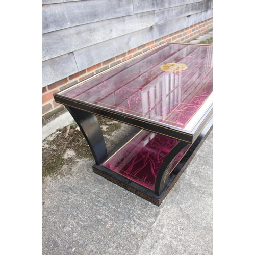 584 - A lacquered and decorated low coffee table, on tapering supports united by an undertier, 44