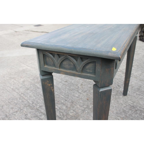 587 - A grey finish carved wood side table with Gothic arch blind fret frieze, on canted square taper supp... 