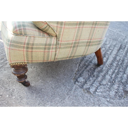 589 - A tub seat armchair, upholstered in a tartan fabric, on turned supports