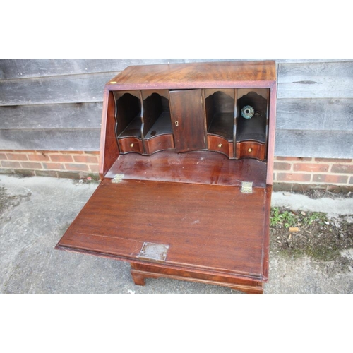 593 - A mahogany and banded fall front bureau, the fitted interior over three long drawers with pierced br... 