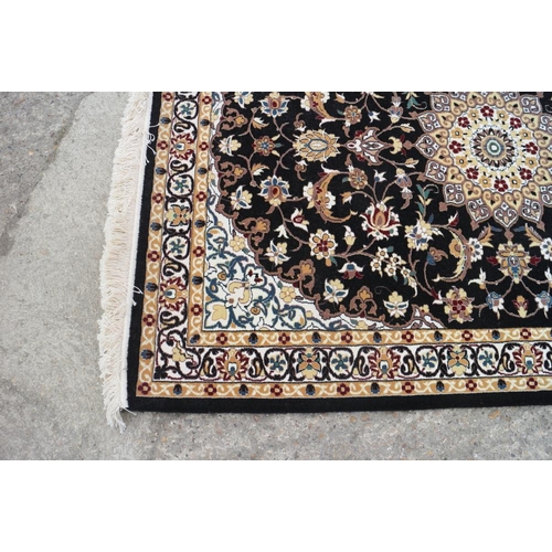 608 - A fine woven full pile rug with Sharbas medallion design on a black ground, 56