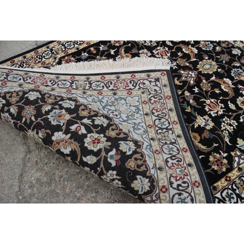 608 - A fine woven full pile rug with Sharbas medallion design on a black ground, 56