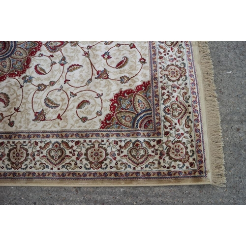 610 - A Kashmir carpet with floral medallions on a gold ground, 90