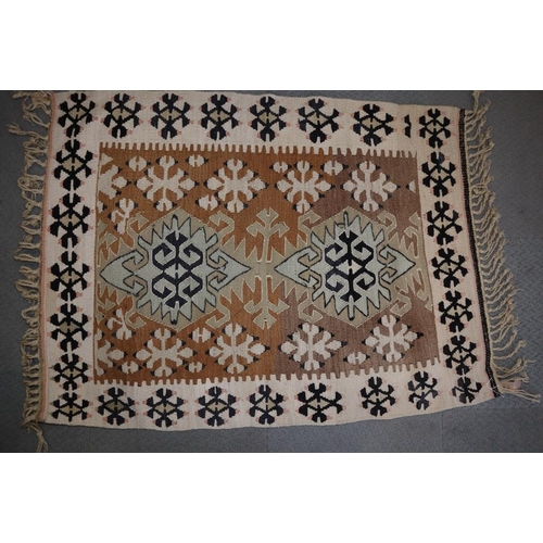 615 - A Kazak kelim rug with two hooked guls on a tan ground, 50