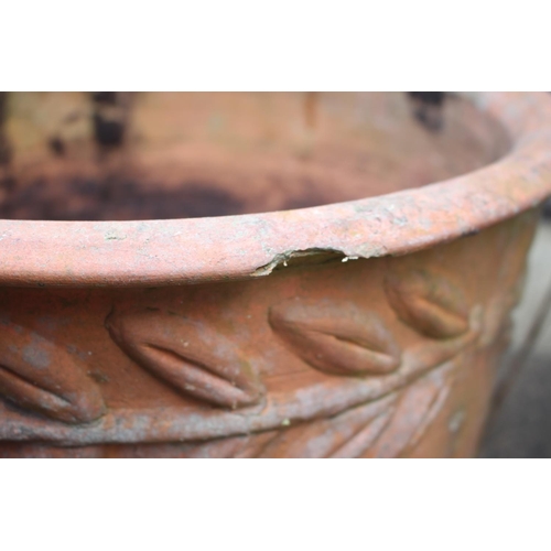 621 - A pair of terracotta plant pots with wheat relief decoration, 17 1/2