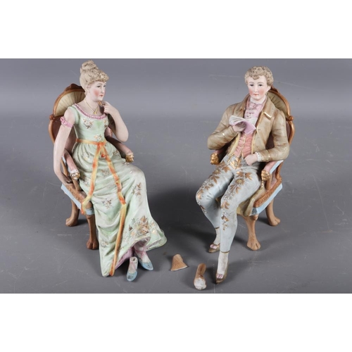 78 - A pair of Continental bisque seated figures, 6 3/4