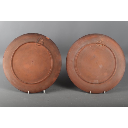 80 - A pair of Watcombe terracotta plates, decorated roses, 12 1/2