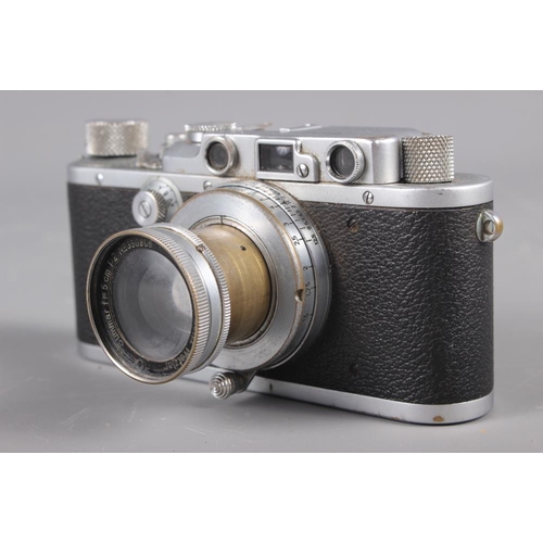 133 - A Leica Rangefinder camera, No 234416, with Summar 50mm f1:2 No 350906, in leather case (shows signs... 