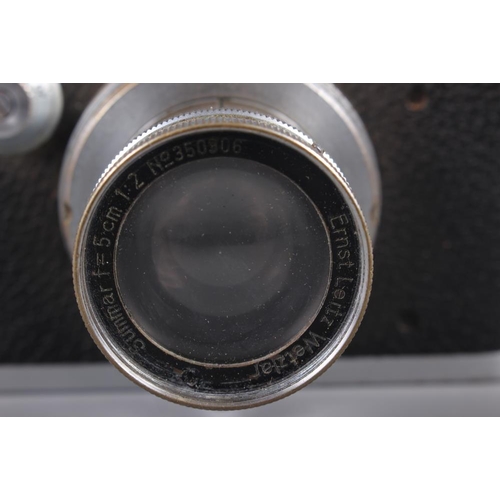 133 - A Leica Rangefinder camera, No 234416, with Summar 50mm f1:2 No 350906, in leather case (shows signs... 