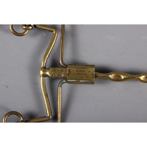 144 - A set of three late 19th century brass fire implements with vase finials and a Beacon patent toaster