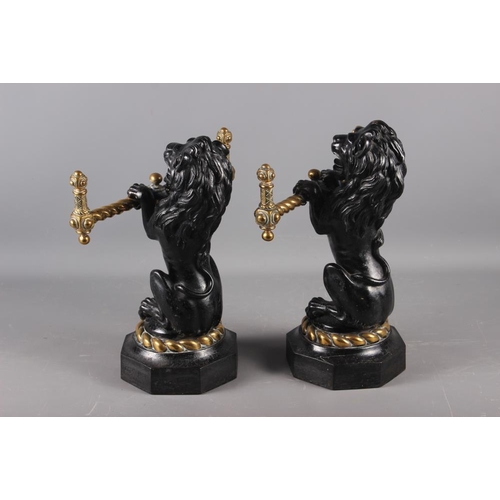 158 - A pair of mid 19th century cast iron and brass lion implement rests/fire dogs, 14