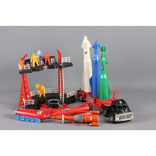 179 - A collection of 1950s and 1960s plastic toys, including space rockets, early Thunderbirds, etc