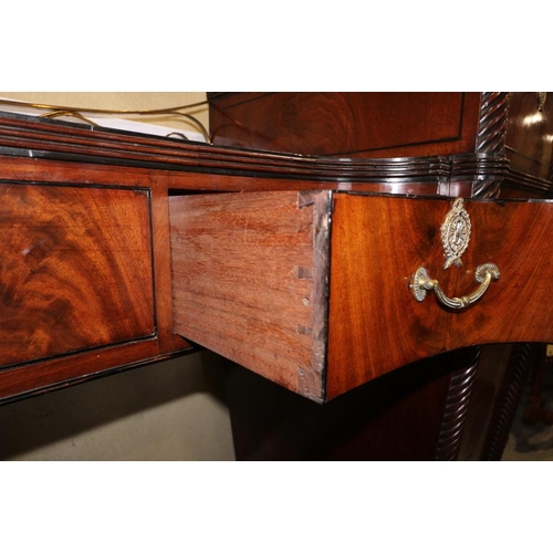 484 - A Regency mahogany and ebony line inlaid inverse break bow drop centre sideboard with brass scroll r... 