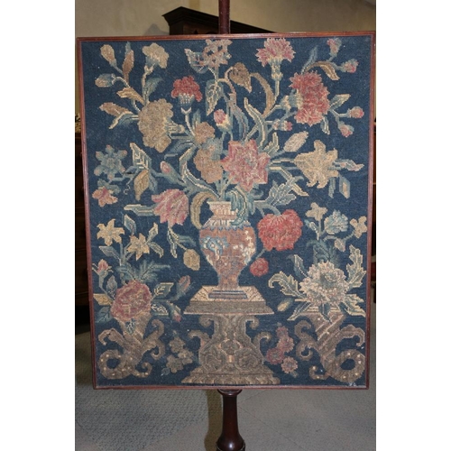 489 - A 19th century mahogany pole screen with gros point panel of vase of flowers, on turned column and t... 