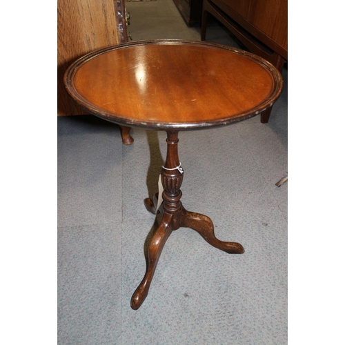 527 - Two polished as mahogany circular topped wine tables, on turned columns and tripod splay supports, a... 