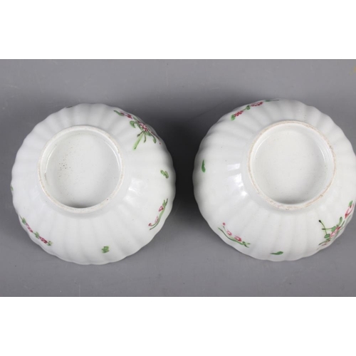 9 - A Newhall (Factory X) cream jug (hair crack) and a pair of similar fluted tea bowls and saucers (fri... 