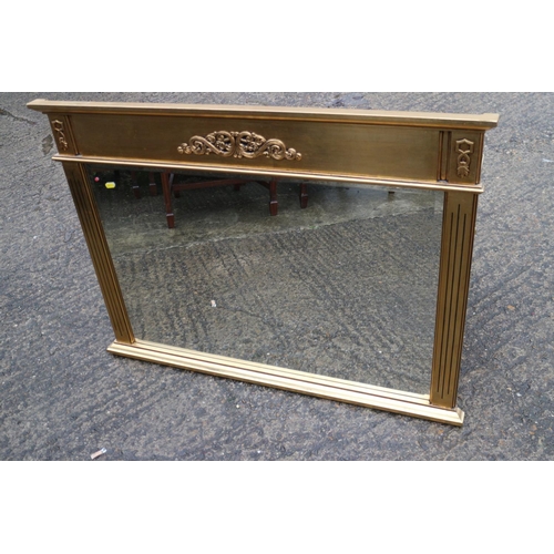 503 - A gilt framed overmantel mirror with scroll decoration and reeded side panels, bevelled plate, 23