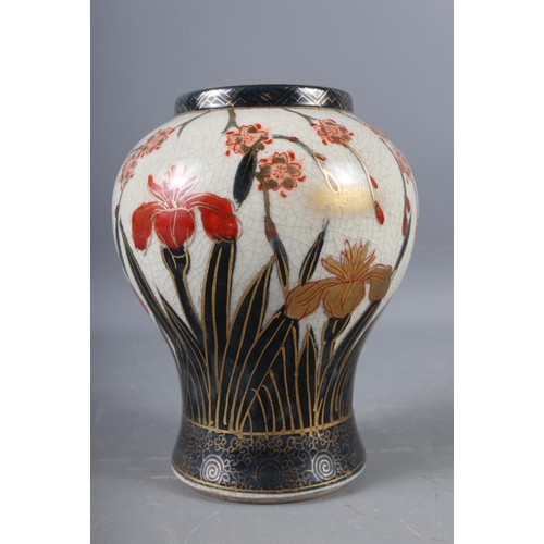 107 - A Japanese blue and white oval shaped vase, decorated trees and figures in a boat (hairline crack), ... 