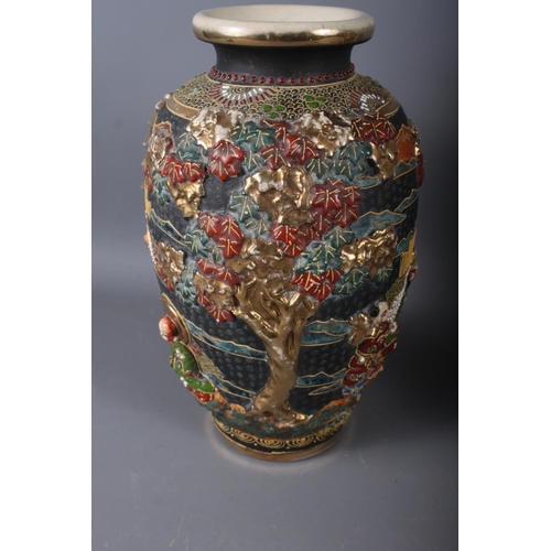 111 - A pair of Japanese baluster vases with relief figure and tree decoration, 10