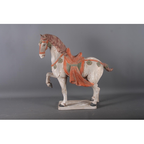 112 - A Tang style painted terracotta model of a horse, 20 1/4