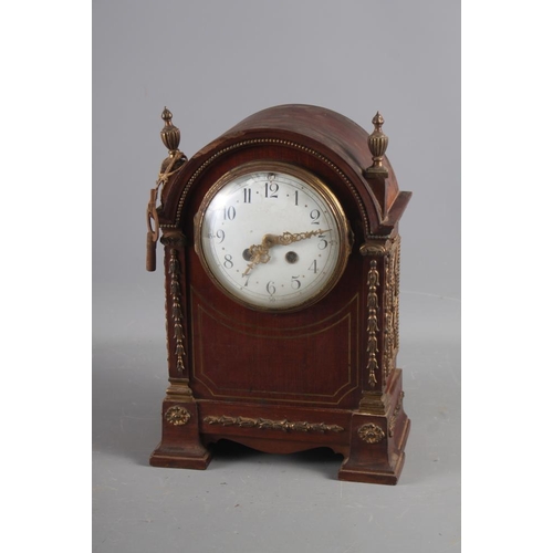 127 - A French? mahogany cased mantel clock with brass decoration, white enamel dial and Arabic numerals, ... 