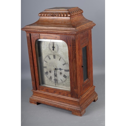 134 - An oak cased bracket clock with chiming movement, silvered dial and Roman numerals, 18 1/2