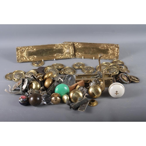 145 - A quantity of mostly brass door handles, finger plates and door fittings