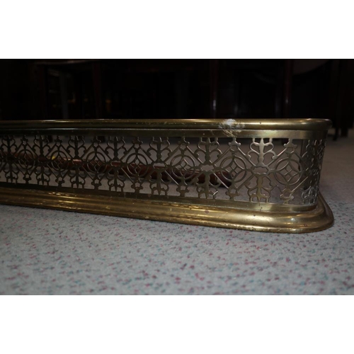 148 - A late Victorian pierced brass fender curb, 58