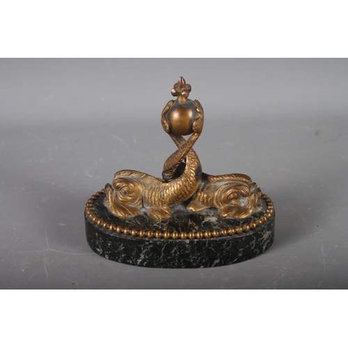 151 - A mid 19th century Continental bronze and marble oval desk weight, formed as two dolphins, 5 3/4