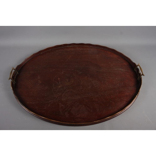 162 - A mahogany oval galleried tray with brass handles, 28