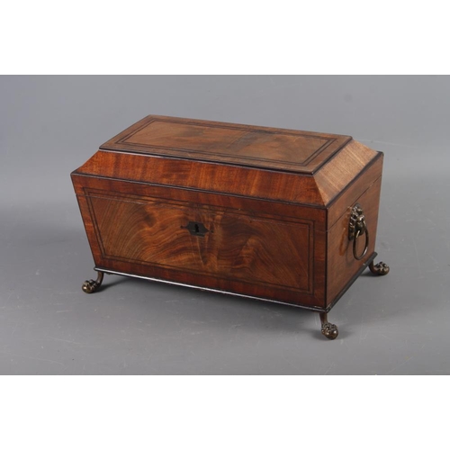 163 - A Georgian mahogany sarcophagus tea caddy with lion ring handles, on claw and ball supports, 13