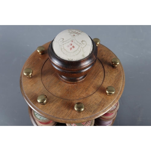 223 - A mahogany revolving bobbin stand with pin cushion, 7 1/2