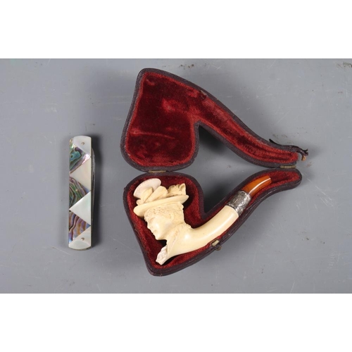 227 - A Meerschaum pipe, formed as a lady's head with white metal mounts and amber mouth-piece (cracked), ... 