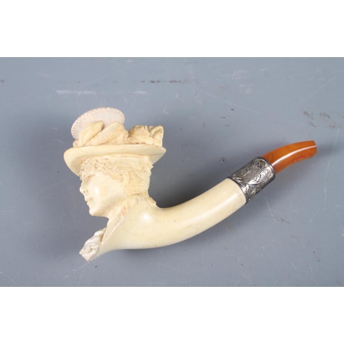 227 - A Meerschaum pipe, formed as a lady's head with white metal mounts and amber mouth-piece (cracked), ... 