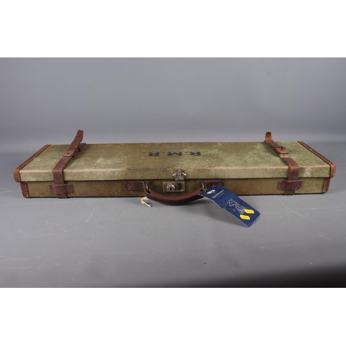 238 - A green canvas and leather bound gun case, initialled 