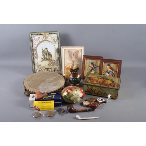 240 - A tambourine, two early 20th century decoupage Easter eggs, a collection of briar pipes, etc