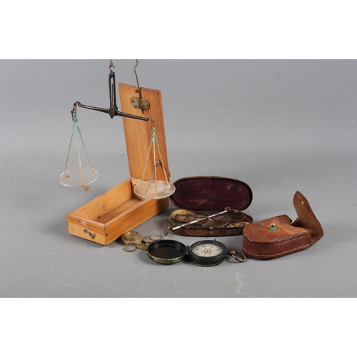 241 - A WWI compass in leather case, an apothecary's balance and weights, in wooden case, and a similar ba... 