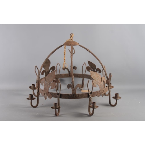 265 - A wrought iron seven-light chandelier with fleur-de-lys decoration, 26 1/2