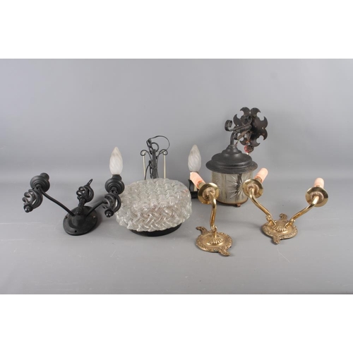 266 - A quantity of wrought iron ceiling and wall lights, and two brass wall lights