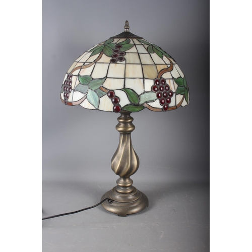 273 - A Tiffany style lampshade with foliage and grape design and a twisted column lamp base, 24 1/3