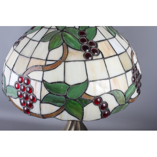 273 - A Tiffany style lampshade with foliage and grape design and a twisted column lamp base, 24 1/3