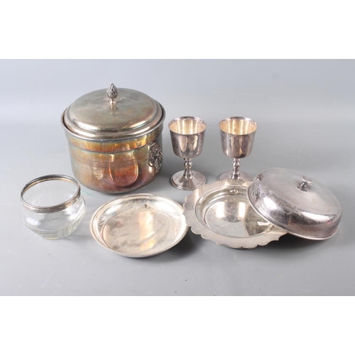 294 - A pair of silver plated goblets, a muffin dish, a Continental white metal topped jar and other items